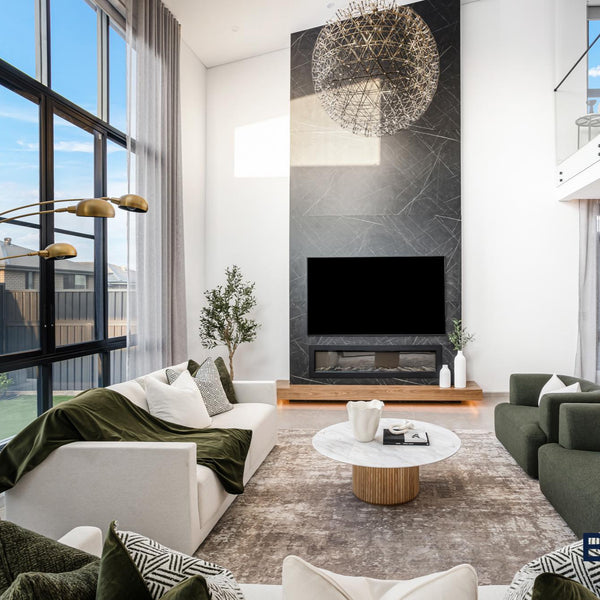 Modern living room with white and gray sofas, a coffee table, and large windows.