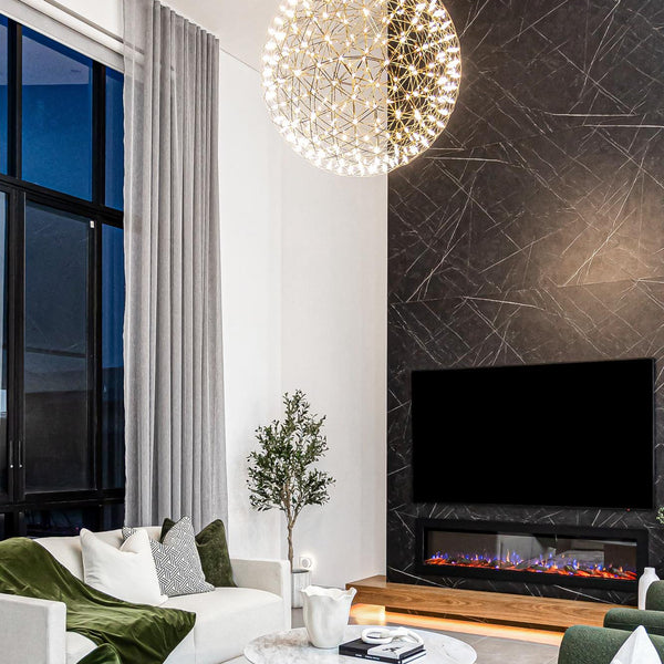 Modern living room with green and white furniture, a fireplace, and decorative lighting.