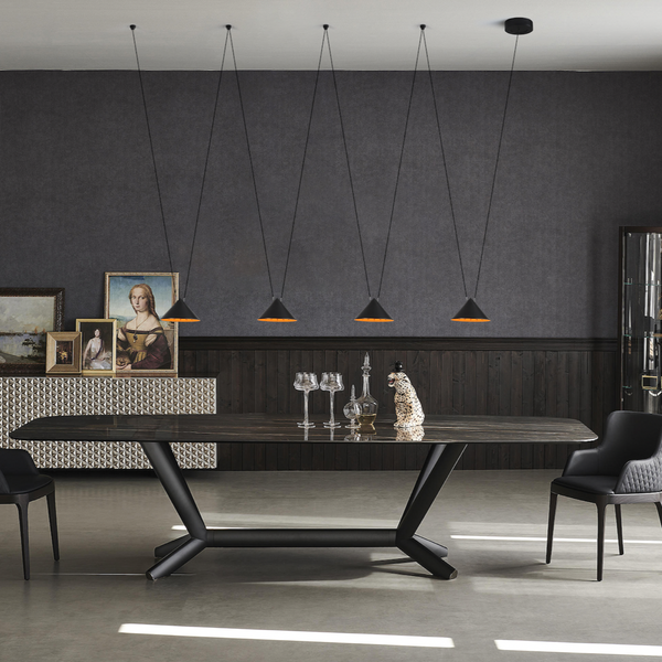 Modern dining room with a black table and chairs, gray walls, and pendant lights.